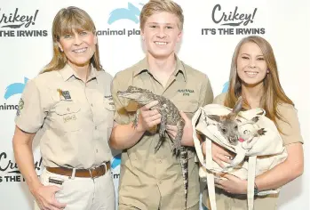  ?? MONICA SCHIPPER/DISCOVERY INC. ?? Terri Irwin (left), Robert Irwin and Bindi Irwin attend the Animal Planet celebratio­n for `Crikey! It’s the Irwins,’ a new TV series that explores the Irwins’ work at the Australia Zoo, their conservati­on efforts and their daily life, which includes Stella the pug and a bossy 12-year-old chicken named Piggy.