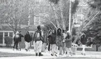  ?? BARBARA HADDOCK TAYLOR/BALTIMORE SUN ?? Students leave Frederick Douglass High School after an early dismissal because of the cold last winter.