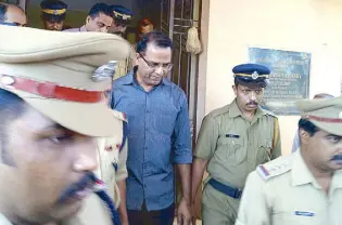  ?? AFP ?? Indian police officials escort priest Robin Vadakkumch­ery after his arrest in Kerala on Saturday.