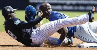  ?? MATT ROURKE, THE ASSOCIATED PRESS ?? Yankees’ Didi Gregorius, left, gets bowled over trying to tag Toronto Blue Jays’ Anthony Alford stealing second.