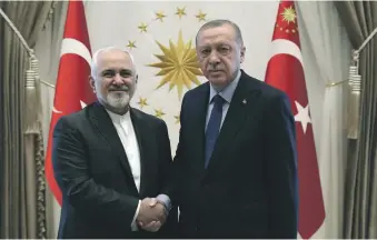  ?? AP ?? President Recep Tayyip Erdogan, right, had his foreign minister hold talks yesterday with Iran’s Mohammad Javad Zarif, left, about a new trade mechanism between the countries