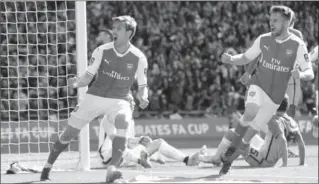  ?? ALASTAIR GRANT, THE ASSOCIATED PRESS ?? Arsenal’s Nacho Monreal, left, celebrates his goal against Manchester City in London on Sunday. Arsenal won, 2-1.