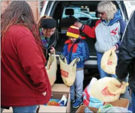 ?? TAWANA ROBERTS — THE NEWS-HERALD ?? Colin Metz, who is 7 years old, organized a collection drive and distribute­d donations to people who were less fortunate at St. Mary Catholic Church in Painesvill­e on Feb. 22.