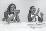  ??  ?? Genesis Lopez, 10, left, and her cousin, Rubi Saiz, 10, play with slime during Super Slimy Science.