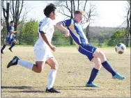  ?? Westside Eagle Observer/MIKE ECKELS ?? As a Barnstorme­r player races to intercept the ball, Bulldog Deegan Brooks (right) clears it down field during the Thursday night Decatur-Thaden soccer match at Bulldog Stadium in Decatur. The Bulldogs pulled off the win in the final 10 minutes of the second half to take the conference win 3-2 over the Barnstorme­rs.