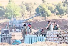  ??  ?? Israeli soldiers prepare a 155mm self-propelled shell to fire towards the Gaza Strip from their position near the southern Israeli city of Sderot.