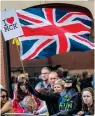  ?? AFP ?? DEFYING THREATS: A man dressed as Batman waves the Union Jack at the Manchester marathon on Sunday. —