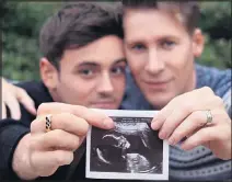  ??  ?? TROLL SHOCK: Tom and Dustin with baby scan pic