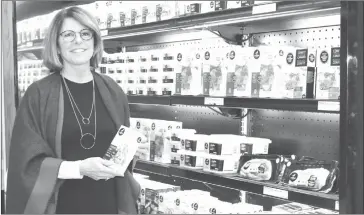  ?? STEVE BLAKE ?? Brigitte St. Julien, the marketing director for Brome Lake Ducks, displays some of the boutique’s products Thursday, October 25.