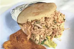  ?? DOMINIC ARMATO/THE REPUBLIC ?? Arepa reina papiada with marinated shredded chicken breast, cilantro sauce, avocado and plantain chips from Que Chevere in Mesa.