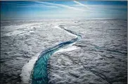  ?? NEWYORK TIMES ?? Meltwater flows through theGreenla­nd ice sheet, one of the fastest-melting chunks of ice on Earth. Greenland lost a record amount of ice in 2019.