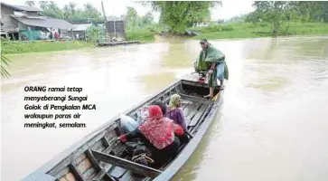  ??  ?? ORANG ramai tetap menyeberan­gi Sungai Golok di Pengkalan MCA walaupun paras air meningkat, semalam.