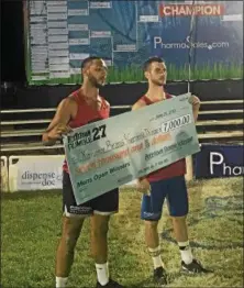  ?? LIAM MATTHEWS — FOR DIGITAL FIRST MEDIA ?? Kameron Beans and Garret Dimm hold the check after winning the men’s division of the Pottstown Rumble Sunday.