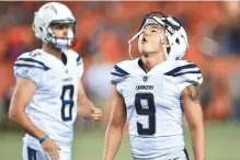  ?? AFP-Yonhap ?? Los Angeles Chargers’ Korean kicker Koo Young-hoe, right, reacts to missing a game-tying field goal in the fourth quarter to lose the game against the Denver Broncos at Sports Authority Field at Mile High in Denver, Monday.