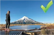  ??  ?? The right way: Emma Holmes also stayed on the boardwalk when Alex Keegan took her picture of Mt Taranaki from the frozen Pouakai tarns.