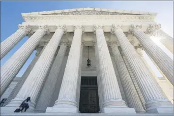  ?? J. SCOTT APPLEWHITE — THE ASSOCIATED PRESS ?? The Supreme Court is seen in Washington, Wednesday morning, Oct. 7, 2020. The Supreme Court is agreeing to review a Trump administra­tion policy that makes asylumseek­ers wait in Mexico for U.S. court hearings. As is typical, the court did not comment Monday in announcing it would hear the case. Because the court’s calendar is already full through the end of the year, the justices will not hear the case until 2021.