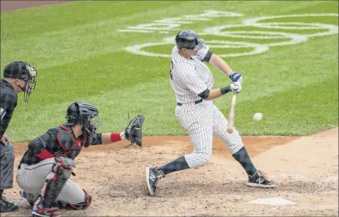  ?? Corey Sipkin / Associated Press ?? New York’s DJ Lemahieu hits a double during the sixth inning against Miami at Yankee Stadium on Saturday, raising his batting average to .359. Lemahieu is closing in on becoming the first player in a century to win batting titles in both leagues.