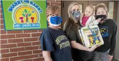  ?? Pam Panchak/Post-Gazette ?? Miriam Messick, left, makes a delivery of books to Shanny the Nanny child care’s owner Shannon Veltre, with daughter Aubrey, 1, and her sister, Brittany Veltre.