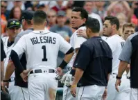  ?? The Associated Press ?? GETTING PHYSICAL: Miguel Cabrera looks back at the New York Yankees as teammates Ian Kinsler, right, and Jose Iglesias (1) guide him off the field during a bench-clearing fight in the sixth inning Thursday in Detroit.