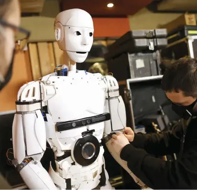  ?? Picture: Reuters ?? #FAKENEWS. Vedran Mujagic, a member of rock group Dubioza Kolektiv, with humanoid robot Robby Megabyte in Sarajevo, Bosnia and Herzegovin­a.