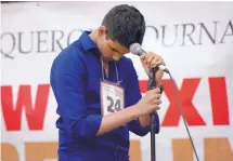  ??  ?? Milidu Jayaweera, an eighth-grader at AIMS in Albuquerqu­e, struggles with a word during the New Mexico Spelling Bee on Saturday. He earned third place in the annual event.