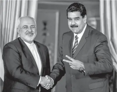  ??  ?? MADURO berjabat tangan dengan Menteri Luar Iran Mohammad Javad Zarif (kiri) dalam pertemuan di Caracas, kelmarin.
