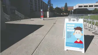  ?? JIM WELLS ?? Signs around the SAIT campus in Calgary remind visitors, staff, students to wear masks while schools remain closed for now.