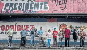  ?? MERIDITH KOHUT/THE NEW YORK TIMES ?? People line up to cast their votes in Caracas on Sunday. President Nicolas Maduro won a second term as president in a contest critics say was heavily rigged in his favour.