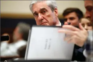  ?? The Associated Press ?? TESTIMONY: Former special counsel Robert Mueller checks pages in the report as he testifies before the House Judiciary Committee hearing on his report on Russian election interferen­ce on Capitol Hill Wednesday in Washington.