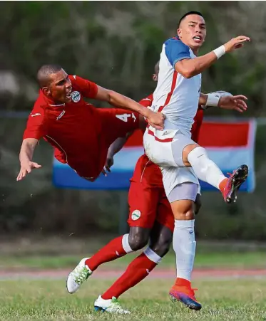  ??  ?? Flying in: Cuba’s Yasmani Lopes Escalante goes airborne as he challenges Bobby Wood of the United States in a friendly in Havana on Friday. The US won 2-0. — AFP