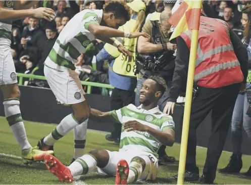  ??  ?? 0 Moussa Dembele celebrates putting Celtic 3-2 ahead with his second goal of the night. Manchester City fought back to make it 3-3.