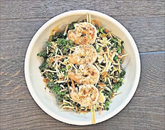  ??  ?? Try the low-calorie quinoa bowls at the Big Ketch Saltwater Grill in Roswell, including the Asian quinoa superfood bowl with shredded yellow beets, Brussels sprouts, broccoli, cauliflowe­r and kale.