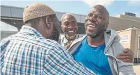  ?? RICK MADONIK TORONTO STAR FILE PHOTO ?? Ebrahim Toure, right, is greeted by friends after his release in 2018. Toure was re-detained last week after the CBSA said he did not disclose a change of address.