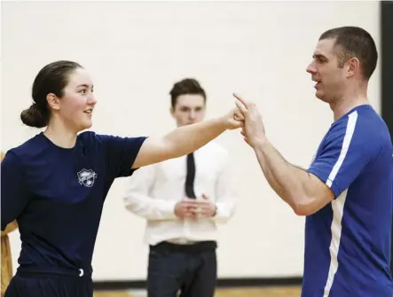  ?? IAN KUCERAK ?? Kate Bekendorf from St. Francis Xavier High School practices punching with Cst. Ben Todd during the fifth annual EPS Youth Recruit Academy at M.E. LaZerte High School on Thursday.