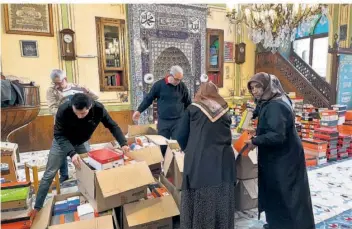  ?? ?? Die richtigen Kleider und Schuhgröße­n für jedes Päckchen hat der Imam selbst bei Ämtern und Gemeinden besorgt: Helfer packen in der Moschee Ramadan-Pakete für bedürftige Kinder.