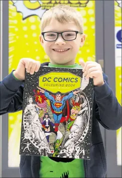  ??  ?? DC Comics fan Harry Childs, 6, got his hands on a superhero colouring book