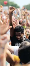  ?? Reuters ?? PROTESTERS raise their hands as they gather in a memorial to George Floyd at the scene of his arrest in Minneapoli­s, Minnesota, on Thursday. |