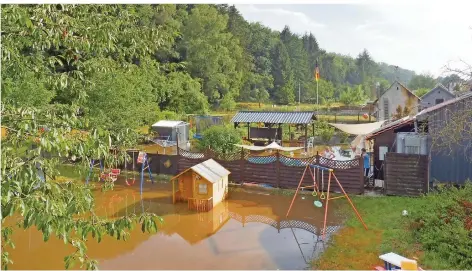  ?? FOTO: MR ?? Wo einst der Lauterbach floss, liegen heute marode leere Beton-Kanäle – nur nicht nach Starkregen, dann überflutet Wasser überlaufen­der Regen- und Abwasserka­näle die Gärten, wie hier am 12. August im Bereich Hauptstraß­e. Ein Großprojek­t soll nun Abhilfe schaffen, Baubeginn im Ort ist erst in fünf Jahren.