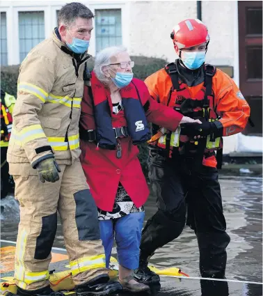  ?? GETTY ?? On the move: Elderly residents are evacuated from a care home by Fire and Rescue emergency services personnel in Northwich following flooding in the north of England