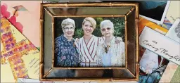  ??  ?? Clarissa Strickland (left), daughter Courtenay Strickland and sister Nan Durrett are seen with sympathy cards last week in Lilburn. Durrett, 74, died last month after falling ill at an assisted living facility.