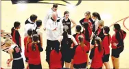  ?? Pea Ridge Times photograph by Mark Humphrey ?? Pea Ridge head coach Heath Neal goes over tactics with the Lady Blackhawks during a 4A-1 girls basketball game at Farmington on Friday, Feb. 11. Pea Ridge lost 72-40 yet Neal quickly turned his attention and that of his team to this week’s district tournament which they host.