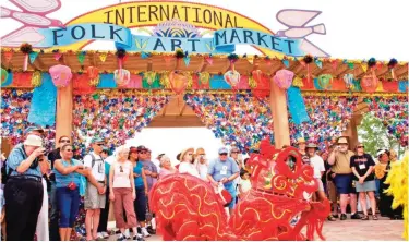  ?? — AP photos ?? Vanh Hanh Vietnamese Lion Dancers entertain the crowd at the Internatio­nal Folk Art Market in Santa Fe, New Mexico.