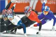  ?? AFP ?? China's Sun Long (in red) competes in the men’s 1,500m semifinals at the World Short-Track Championsh­ips on Saturday. Sun won the title after South Korean Huang Dae-heon was disqualifi­ed.