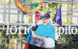  ?? STEPHEN M. DOWELL/ORLANDO SENTINEL ?? Two pro-Trump protesters from Jacksonvil­le take a selfie at the Florida Capitol in Tallahasse­e on Wednesday.