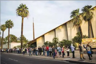  ?? MAX WHITTAKER / THE NEW YORK TIMES FILE (2016) ?? Hundreds of people wait in line to vote in 2016 at a polling site at a church in Phoenix. In 2016, Brnovich v. Democratic National Committee was filed to challenge voting restrictio­ns in Arizona. Today, the Supreme Court will hear the case, one of its most important election cases in almost a decade.