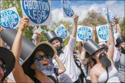  ?? AP file photo ?? Protesters dressed as Abraham Lincoln chant during a Planned Parenthood rally in support of abortion access outside the U.S. Supreme Court, April 15, in Washington. A new poll from from AAPI Data and The Associated Press-NORC Center for Public Affairs Research shows that Asian Americans, Native Hawaiians and Pacific Islanders in the U.S. are highly supportive of legal abortion, even in situations where the pregnant person wants an abortion for any reason.