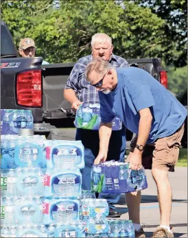  ?? Kevin Myrick /
Standard Journal) ?? Stacks of water bottles are lined up in front of First Presbyteri­an Church of Cedartown on Sept. 2 in an event held to gather supplies for Hurricane Harvey relief efforts in Texas.