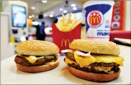  ?? ASSOCIATED PRESS ?? A MCDONALD’S QUARTER POUNDER (left) and Double Quarter Pound burger are shown with fresh beef March 6 in Atlanta. McDonald’s is offering fresh beef rather than frozen patties in some burgers at thousands of restaurant­s, a switch it first announced...