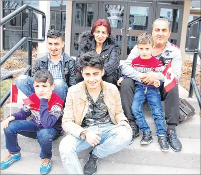  ?? JIM DAY/THE GUARDIAN ?? Joseph and Basma Tomas sit on the steps outside of Central Christian Church in Charlottet­own with their four children: Odiss; Thomas; Andrew and Peter. The Syrian family arrived in P.E.I. to begin a new life after waiting years for the major move to be...