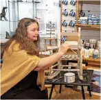  ??  ?? Jan Ferguson paints props for the Panache Gallery. Shelves are lined with Cornish blue and white pottery.